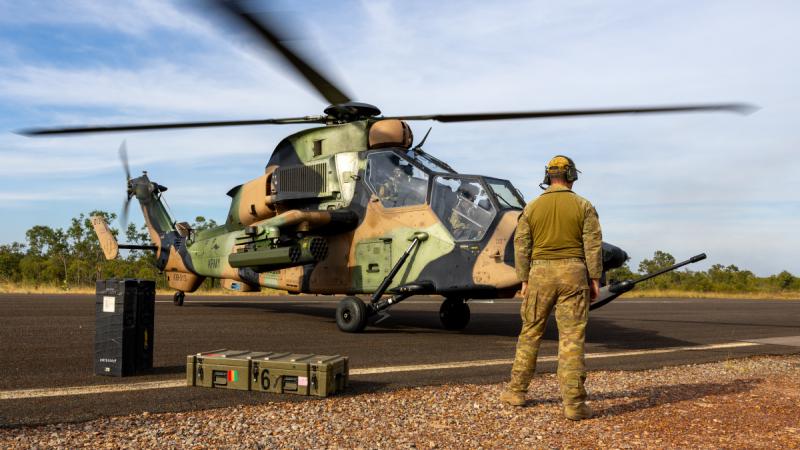 An Australian Army ARH Tiger helicopter is rearmed at a Forward Arming and Refuelling Point at the Mount Bundey Training Area during Exercise Griffin Guns at the Northern Territory.