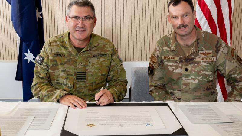 Group Captain Paul Murray, Officer Commanding 95 Wing, Royal Australian Air Force, and Lieutenant Colonel James Sinclair, Deputy Commander 36 Contingency Response Group, US Air Force, sign a sister squadron arrangement at RAAF Base Amberley.