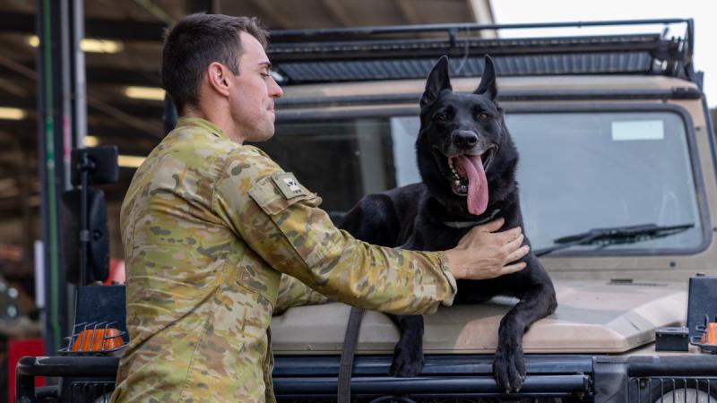 Lance Corporal Jared Willis with his military working dog Dirk at Roberston Barracks in Darwin.