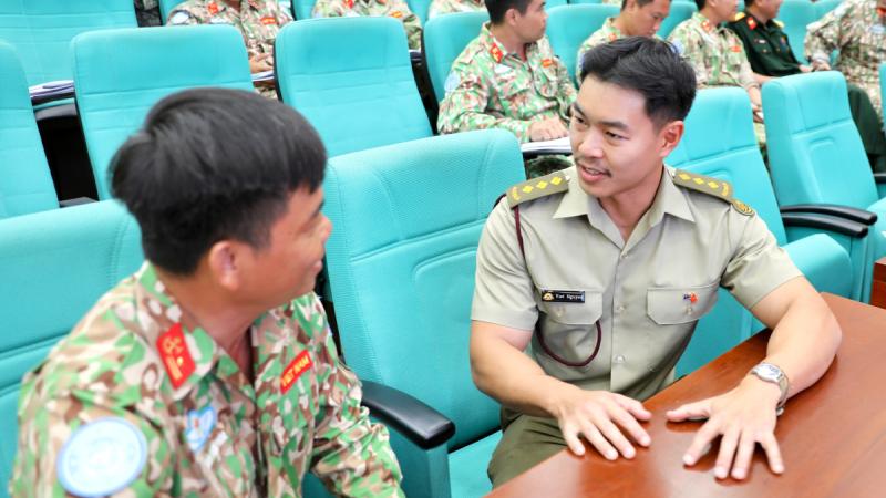 Captain Brendan Nguyen engages with a student during mental health training in Ho Chi Minh City.