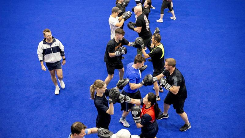 Leading Seaman Physical Training Instructor Ben Stewart leads a boxing session in support of local not-for-profit group, Stepping Stone House.