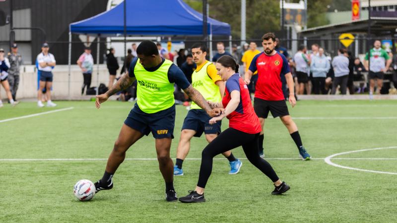 A United States Navy sailor from USS Blue Ridge dribbles the ball during the futsal competition at HMAS Kuttabul in Sydney, NSW. 