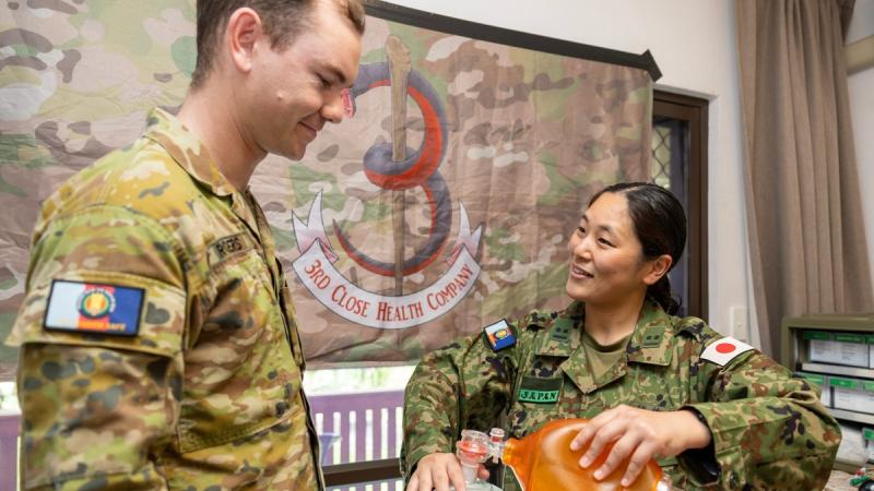 Australian Army Private Kamarga Rogers, from 3rd Close Health Battalion, discusses medical techniques with Lieutenant Susami Shiori of the Japan Self-Defense Force during Operation Render Safe. 