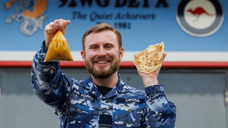 Operation Gateway 25-1/2 Deputy Detachment Commander, Flight Lieutenant Alex Cross, displays roti and curry, some of Operation Gateway's most important logistics requirements at Royal Malaysian Air Force Base Butterworth in Penang.