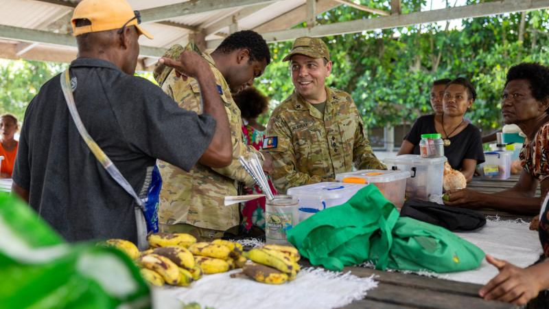 Australian Army chaplain Captain Andrew Murray speaks with members of the local community alongside Papua New Guinea Defence Force personnel in Kokopo, East New Britain, during Operation Render Safe.