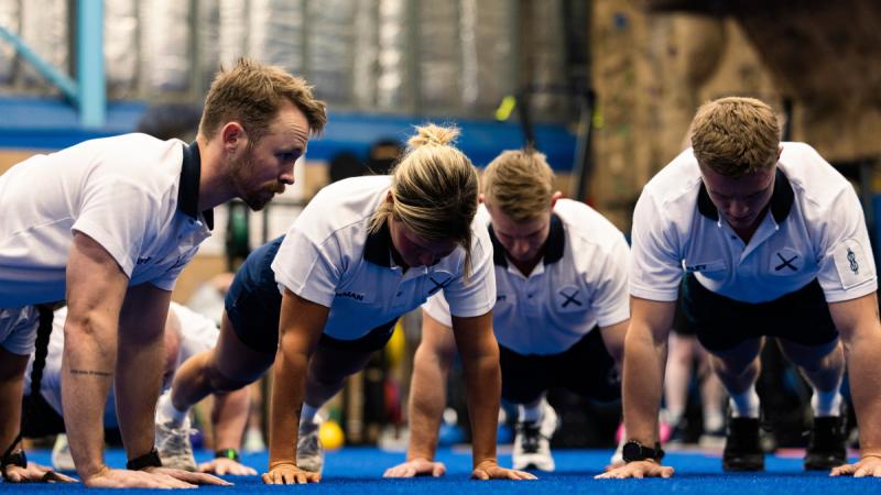 Royal Australian Navy Physical Training Instructors participate in the Push Up Challenge at Fleet Base East Gymnasium in Sydney, NSW.