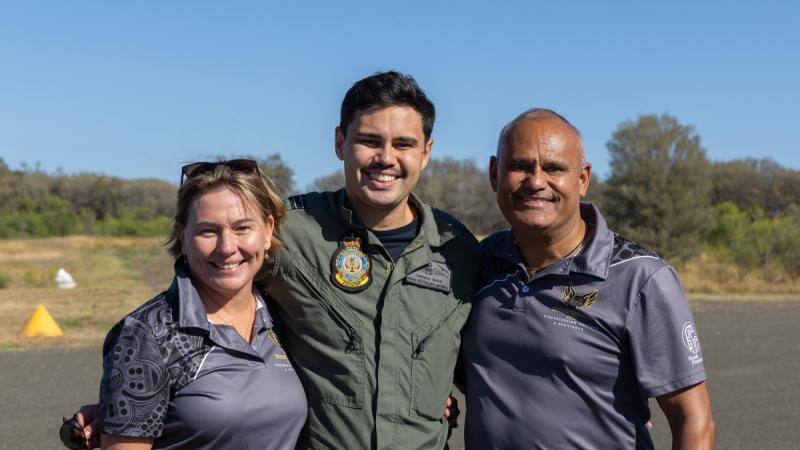 C-130J Hercules pilot and Murrawarri man, Flight Lieutenant Tjapukai Shaw, with friend Sarah Plumley and his father, Zeke Shaw, (L to R) during a community engagement event at Brewarrina Airport.