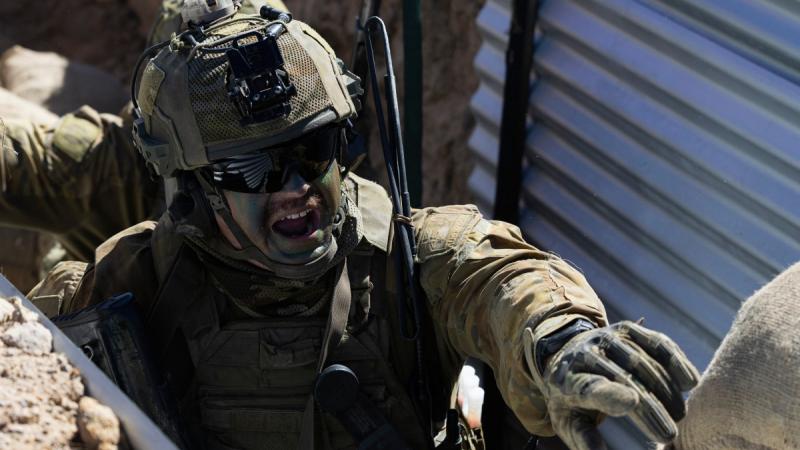 An Australian Army soldier from the 1st Battalion, The Royal Australian Regiment, delivers orders during a blank fire trench serial at Townsville Field Training Area. 
