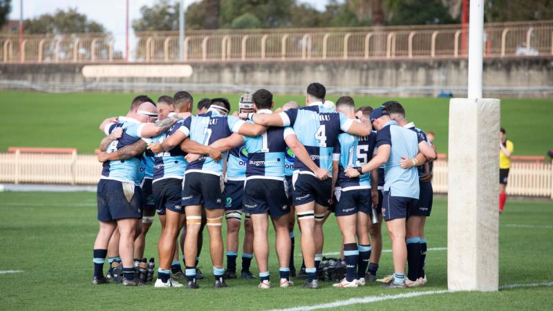 Air Force men's team form a huddle in the 2024 ADF Rugby Union Championships at North Sydney Oval, NSW.