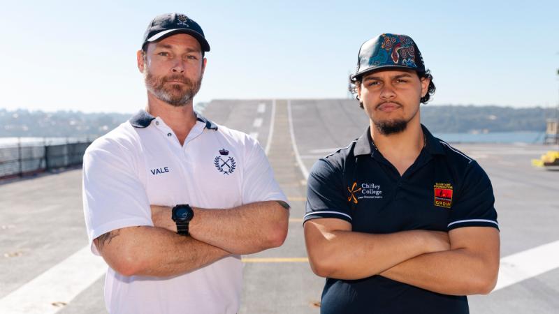 Physical training instructor Chief Petty Officer Christopher Vale, left, with Chifley College student Tuqiri Donnelly on the deck of HMAS Canberra during a visit to Fleet Base East in Sydney.