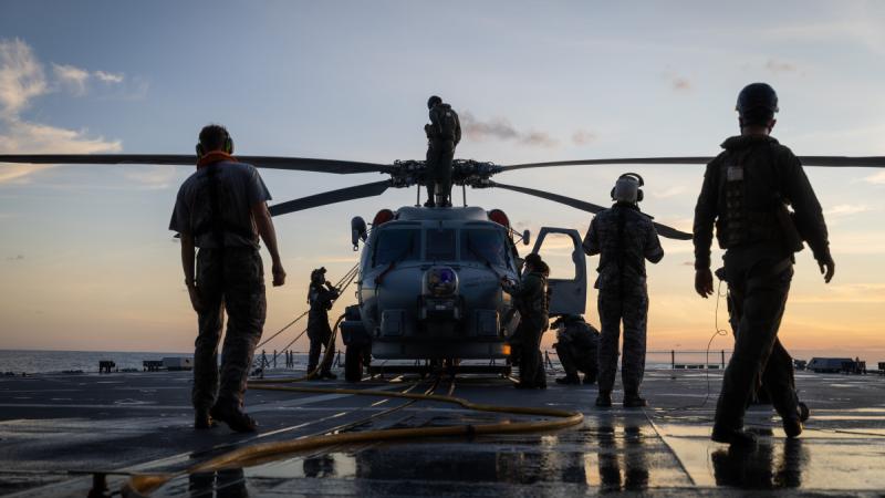 HMAS Sydney's flight crew prepare MH-60R helicopter Electra for flying operations during Regional Presence Deployment 25-2.
