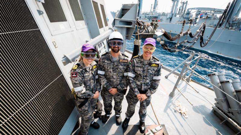 Left to right, Lieutenant Hannah Roberts, Petty Officer Matthew Samson and Lieutenant Commander James Stahlhut on board HMAS Sydney during a replenishment at sea with Japanese Ship Mashu.
