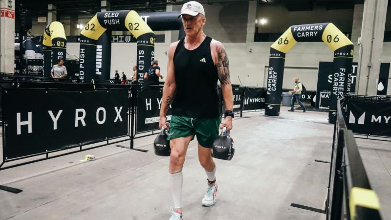 Lieutenant Colonel Simon O’Regan takes on the farmer's carry station during the HYROX World Championships in Chicago. 