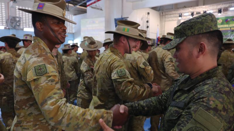 Philippine Army and Australian Army soldiers shake hands after the Australians were presented with patches of the Philippines’ 4th Infantry Division during the closing ceremony of Ex Kasangga at Camp Evangelista in Northern Mindanao. 