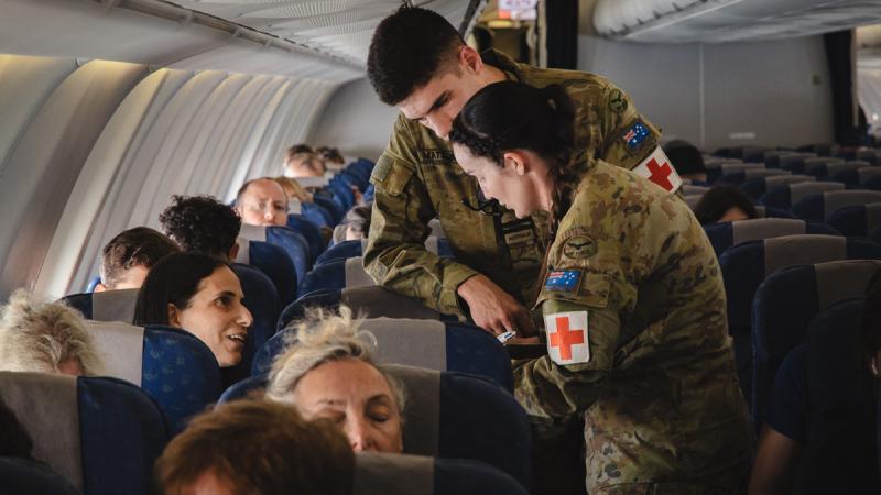 Australian Defence Force medical personnel provide assistance to Australian citizens on board a Royal Australian Air Force KC-30A aircraft during a military assisted departure from Tel Aviv, Israel, as part of Operation Beech.