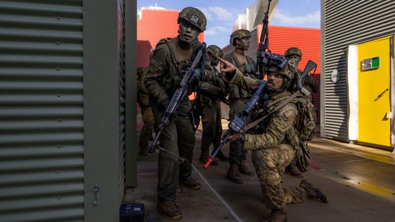 Australian Army soldiers from 8th/9th Battalion, Royal Australian Regiment, and Republic of Fiji Military Forces conduct an assault on the urban operations training facility during the South Queensland Warfighter Exercise in Shoalwater Bay, Queensland.