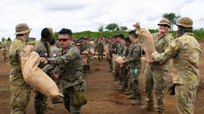 Australian and Philippine Army sappers move sandbags during joint training at Camp Kibaritan in Northern Mindanao. 