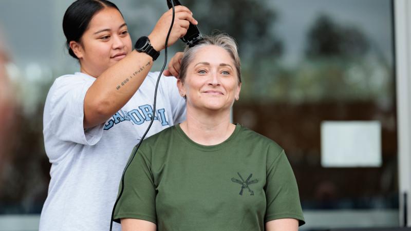 Executive Officer of 2 Security Forces Squadron, Squadron Leader Tai Kohn, has her head shaved after the squadron completed 3521 laps around the RAAF Base Amberley running track to raise funds to fight ovarian cancer. 