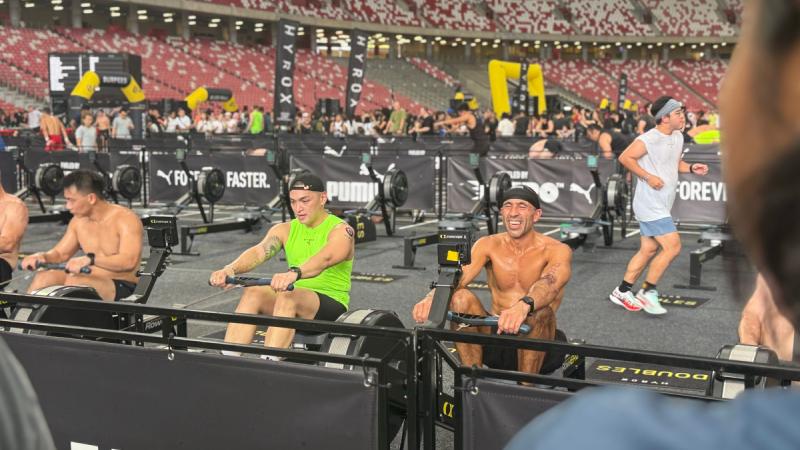Able Seaman Filipe Crispim dos Santos, right, competes in the HYROX fitness competition in Singapore during regional presence deployment.