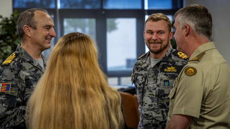 Chief of Defence Force Admiral David Johnston speaks with Lieutenant Commander Jason Burford and his parents during an award ceremony for the Australian Operational Service Medal - Indo-Pacific at HMAS Harman. 