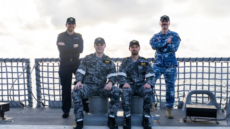 Royal Navy Lieutenant Paul 'Buck' Rogers, Royal Australian Navy Lieutenant Hayden Knight, Royal Australian Navy Petty Officer James Moore and Royal Australian Air Force Flying Officer Frank Headley on the flight deck of HMAS Sydney. 