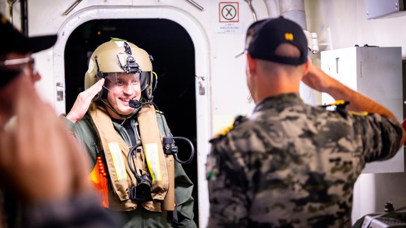 Commander United Kingdom Carrier Strike Group, Royal Navy Commodore James Blackmore is welcomed on board HMAS Sydney. 