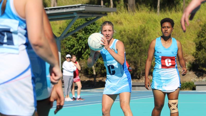 Tournament MVP Leading Aircraftwoman Tahli Wheeler, from 1 Squadron, controls the pace of the game during the grand final at the International Netball Festival.