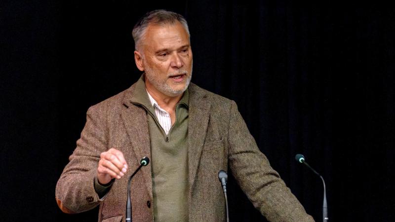 Professor Stan Grant speaking at a lectern at Ngunnawal Theatrette.