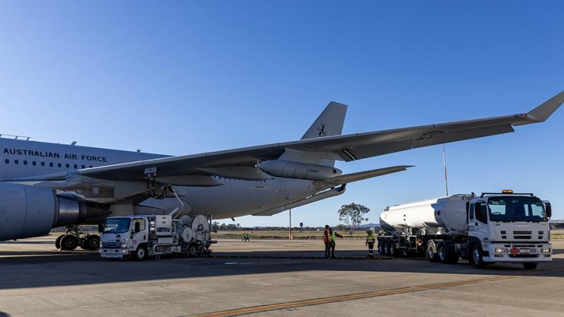 An Australian Air Force KC-30A Multi-Role Tanker Transport aircraft being refueled at RAAF Base Amberley, against the backdrop of a blue sky. 