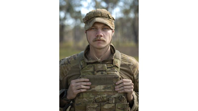 Solder in uniform grips vest.