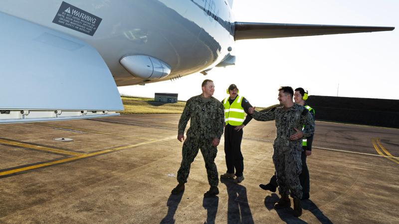 Aviators from 11 Squadron Royal Australian Air Force, 5 Squadron Royal New Zealand Air Force and sailors from the United States Navy inspect a RAAF P-8A Poseidon aircraft at RAAF Base Townsville.