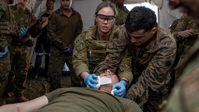 Medical staff attend to a patient in training exercise