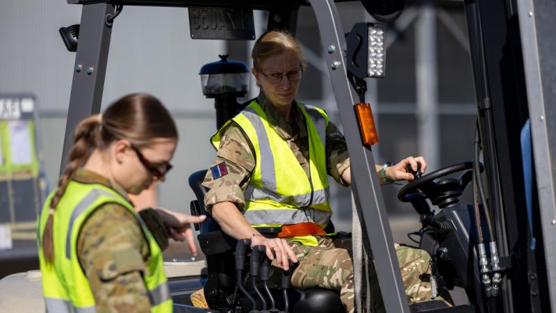 Royal Air Force aviator Air Specialist (Class 1) Kate Aldershaw operates a forklift while working with Royal Australian Air Force aviator Leading Aircraftwoman Georgia Dewhirst at RAAF Base Amberley during Exercise Talisman Sabre 2025. 