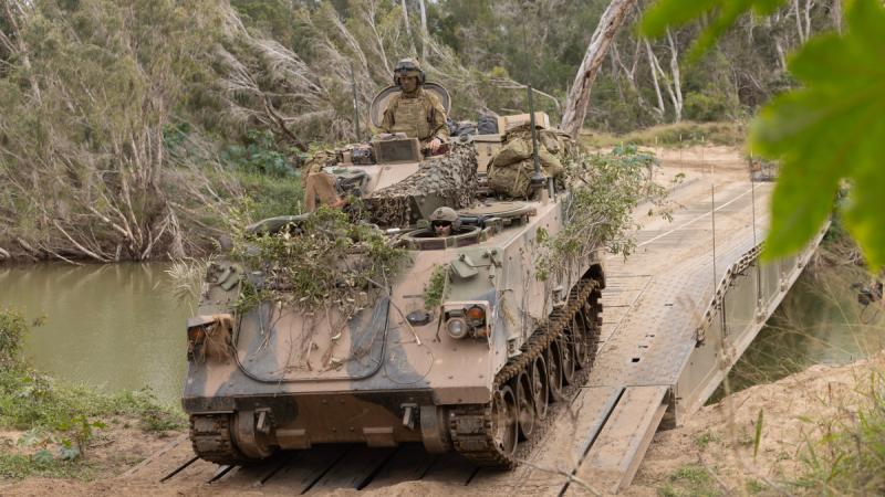 Australian Army heavy vehicles cross a Dry Support Bridge built by soldiers from the 3rd Combat Engineer Regiment during Talisman Sabre 2025 at Townsville Field Training Area.