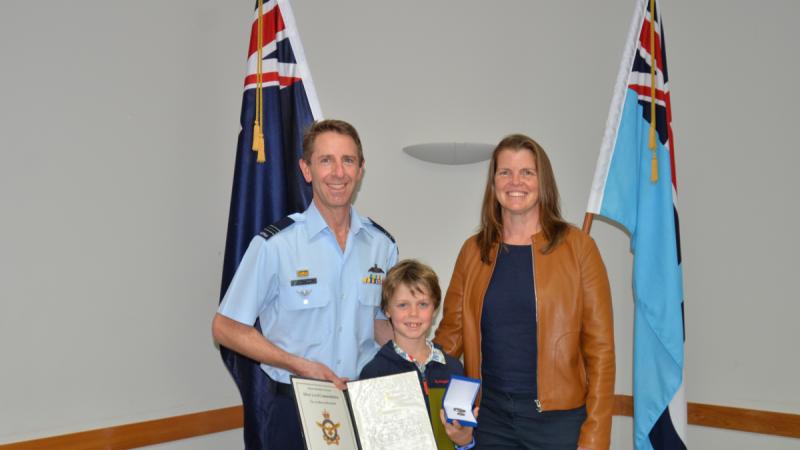 Squadron Leader Paul Jeffery, left, with his family in Auckland after being awarded a Royal Australian Air Force Silver Commendation.