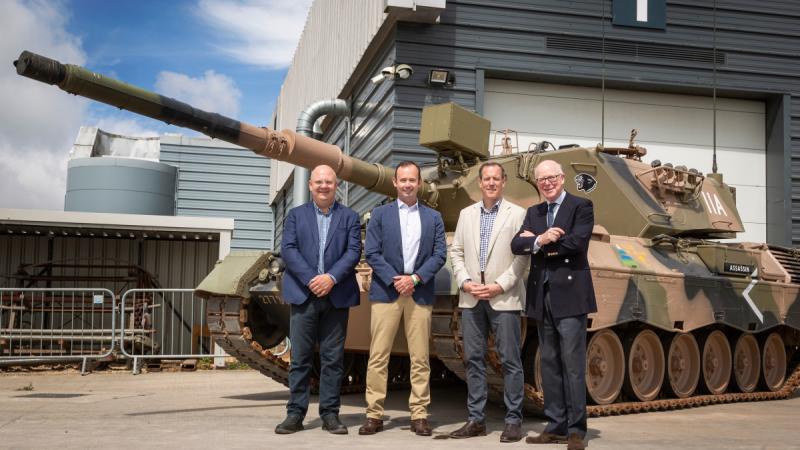 Australian Army Leopard AS1 tank is presented by, left to right, Colonel Michael King and Lieutenant Michael Henderson of the Australian Army to Lieutenant General Sir William Rollo and Chris Pearce of the Tank Museum, United Kingdom. 