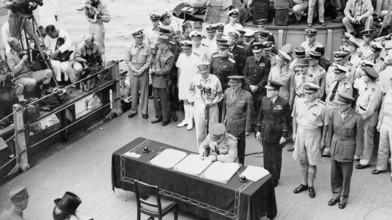 The signing of the surrender document by Allied personnel and representatives of the Japanese forces aboard the United States battleship Missouri, September 2, 1945.