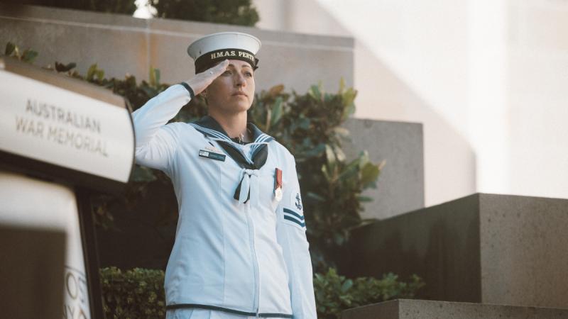 Petty Officer Amanda Prins salutes during the Australian National Anthem for the Last Post Ceremony at the Australian War Memorial in Canberra.