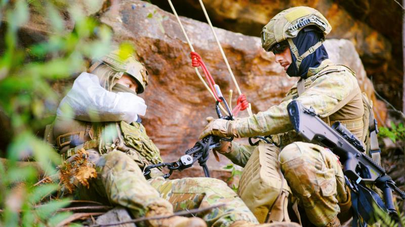 Members on the Tactical Rope Rescue Instructors’ Training Course practise a simulated casualty rescue at Holsworthy Training Area.