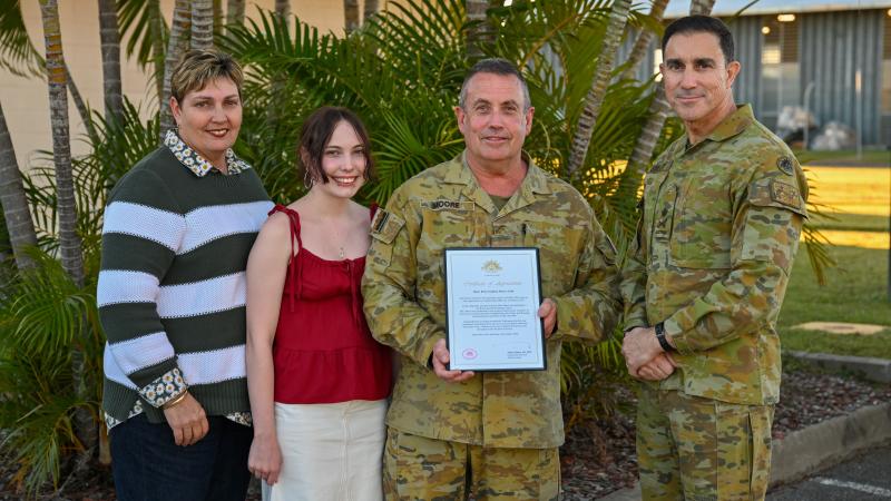 Major Brian Moore receives his Federation Star from Chief of Army Lieutenant General Simon Stuart, right,  in the presence of family members.
