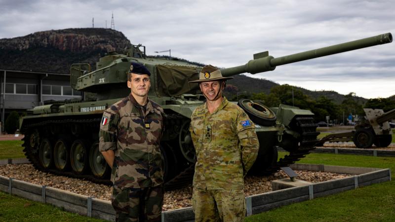 Captain Antoine Lefeuve (left) and  Commander 3rd Brigade, Brigadier Benjamin McLennan (right) standing in front of a decommissioned tank.