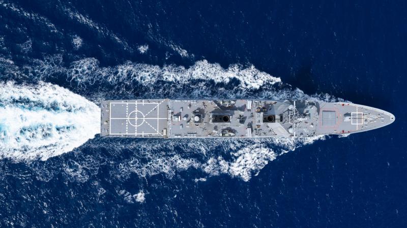View from above of a Navy destroyer sailing in the open sea.