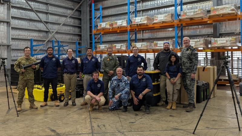 Australian Defence Force and Public Service personnel with data testing equipment on Exercise Talisman Sabre.