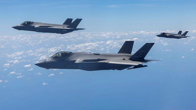 Three aircraft flying in the sky.