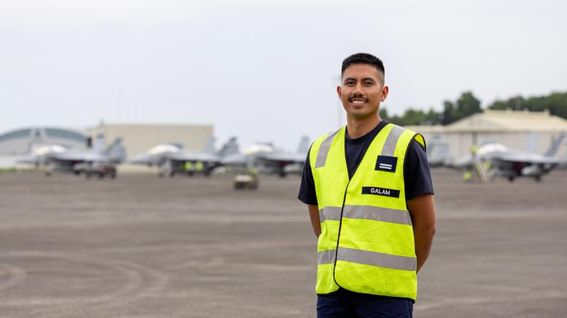 Flight Lieutenant James-Andre Galam stands in high-vis at Clark Air Base, Philippines.