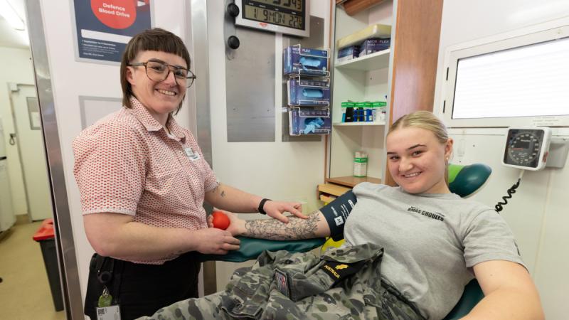 A nurse preparing getting a patient ready to donate blood.