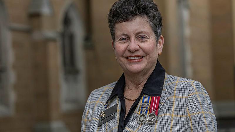 A woman with military medals on her lapels.