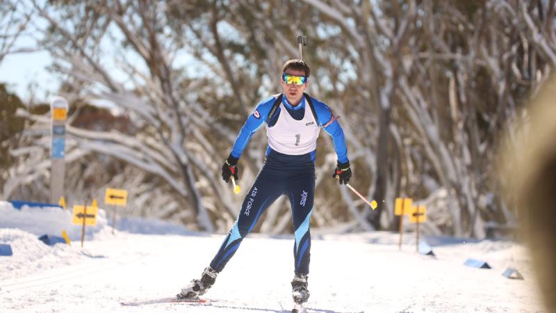 A man going down a snow-covered hill on skis.