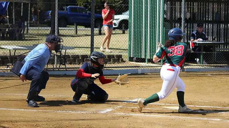 A plate umpire, catcher and batter during a softball game.
