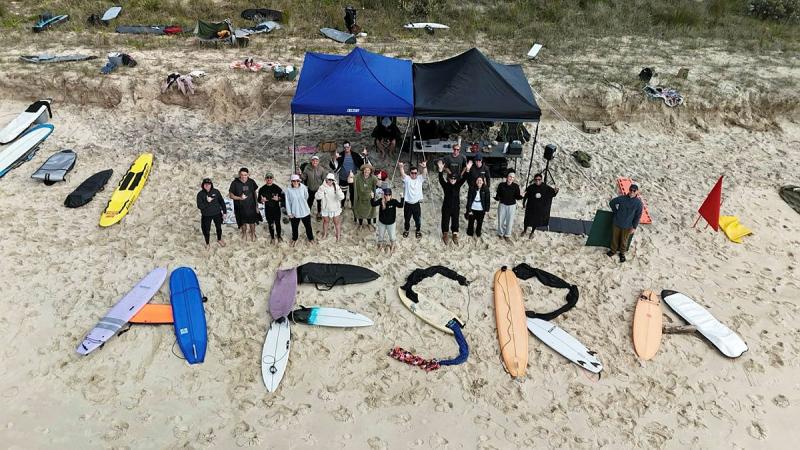 A Birdseye view of a group of people on the beach with the acronym AFSRA spelt in boards and clothes.